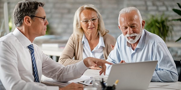 insurance agent sitting with clients