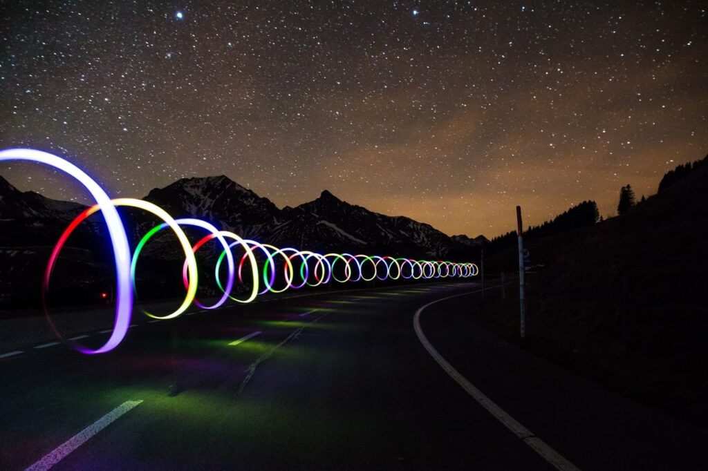 giant loops of visualized data traveling down a desert road at night